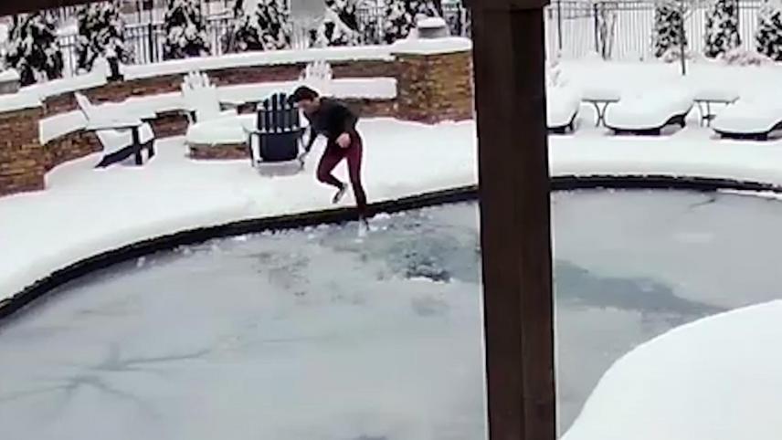 210224165809-lady-jumping-in-frozen-pool-to-save-dog