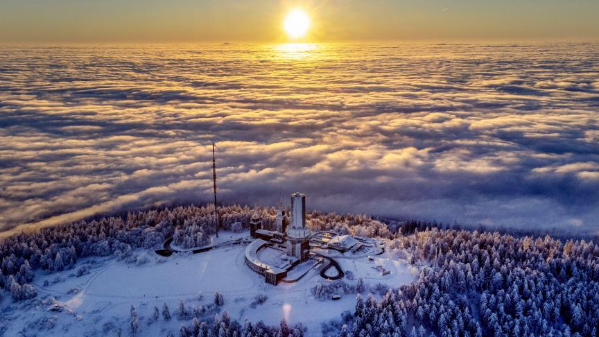 Le soleil se lève sur le sommet de la montagne Feldberg alors que les environs sont couverts de brouillard près de Francfort, en Allemagne, ce mercredi 25 janvier 2023.